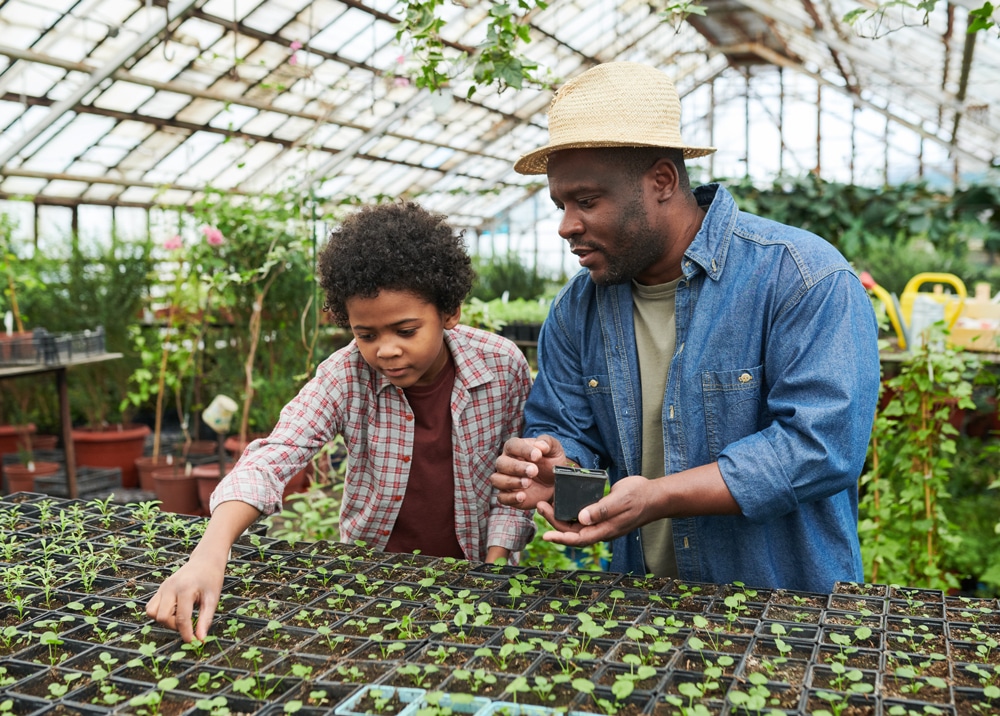 Man with child in greenhouse